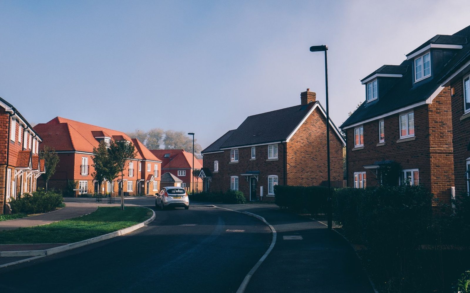 Red-brick houses on a quiet suburban street in the UK